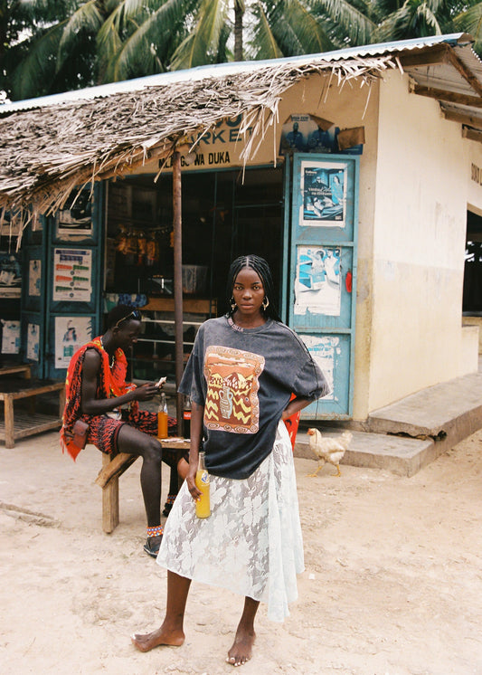 Woman wearing light blue lace skirt and an oversized black graphic tee