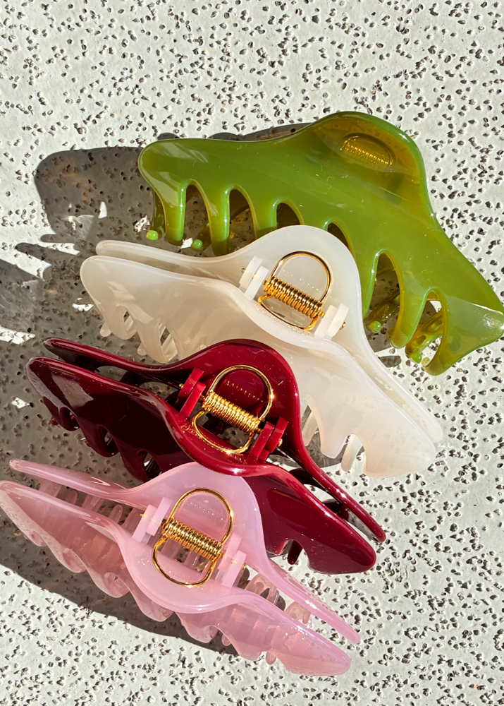 Set of colorful claw clips on a textured surface