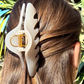 White claw clip in a person's hair with a natural background