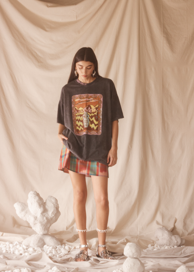 Woman wearing a black graphic t-shirt with desert print