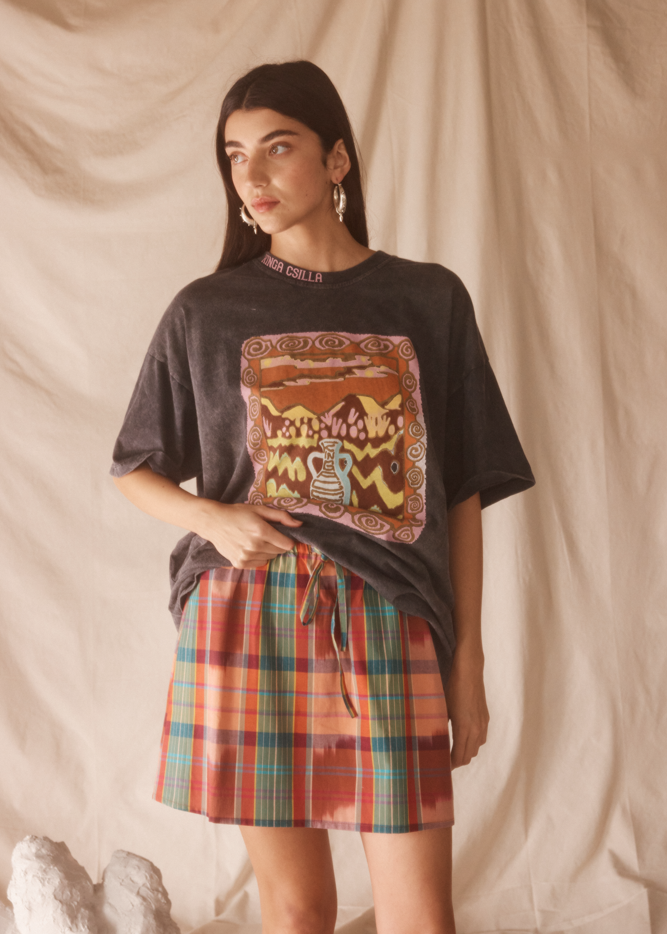 Woman wearing a black graphic t-shirt with desert print