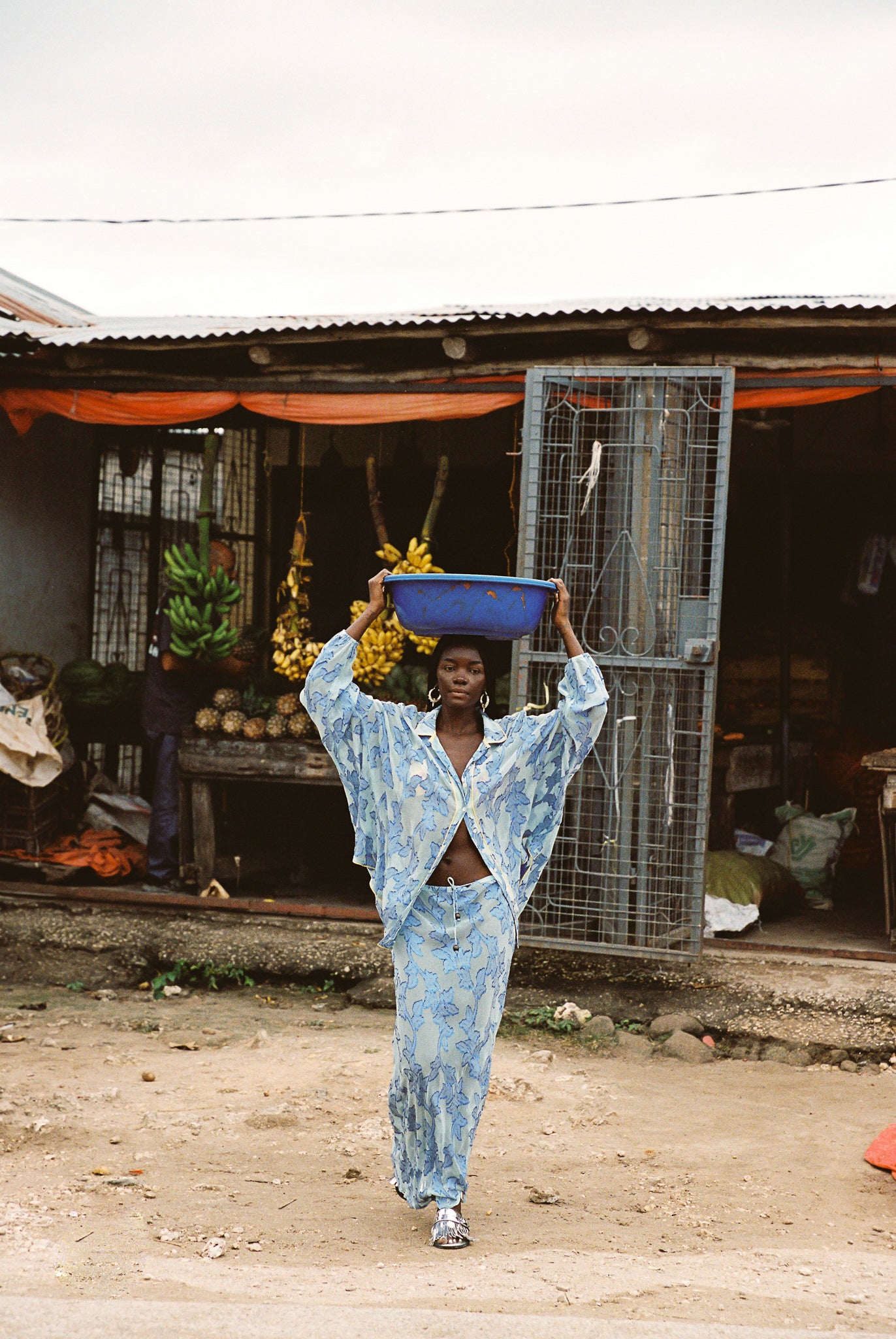 Woman in semi-sheer blue botanical embroided skirt and skirt set.