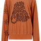 Kinga Csilla Abracadabra OG Jumper in warm orange with oversized fit, KC graphic print across chest and swirly sun motifs on sleeve