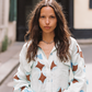 Model wearing Kinga Csilla Aquarius Chalm Shirt in baby blue linen with celestial brown and blue print, street style front view