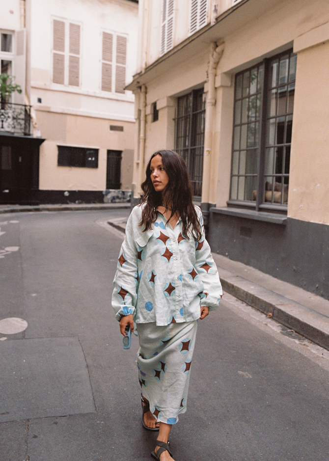 Side angle of Kinga Csilla Aquarius Column Skirt styled with matching Aquarius Chalm Shirt, baby blue linen with celestial star print