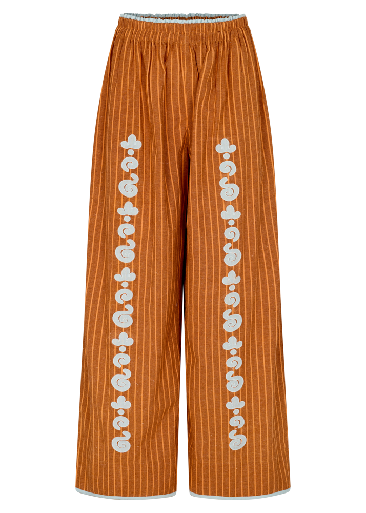 Kinga Csilla Bello Swirl Jessi Pant in earthy orange with white swirl embroidery, wide-leg silhouette and elastic waistband.
