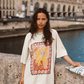 Model wearing Kinga Csilla Hibiscus Tee with oversized fit and stamp-style hibiscus print, photographed riverside in Paris
