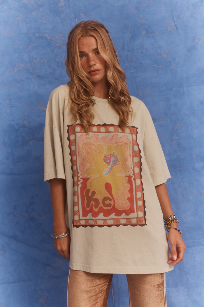 Studio shot in Kinga Csilla Hibiscus Tee paired with TWILIGHT VELVET FLARE PANT, modern bohemian styling.