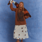 Model wearing Kinga Csilla Lino Roses Tee brown long sleeve styled with Aquarius Slip Dress, brown sandals and Surf Citta Cardigan draped over shoulders, styled in front of a blue studio backdrop