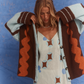Model wearing the Kinga Csilla Surf Citta Cardigan, a bohemian-inspired knit in brown, orange and blue, layered over the Aquarius Slip Dress.