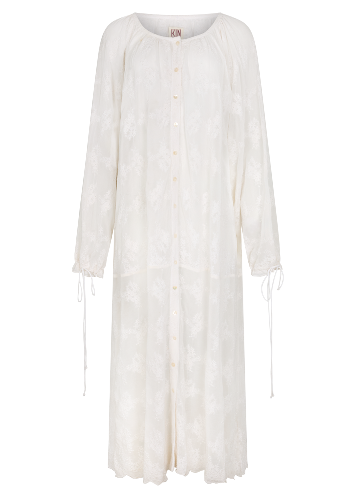 Front view of the Kinga Csilla Tottori Lace Harlow Maxi Dress in white embroidered cotton, long sleeve button-down silhouette with scalloped hemline.