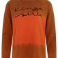 A long-sleeve crewneck shirt in a rust-orange color gradient with black script text reading 'Kinga Isilla' across the chest, displayed on a clean white background.