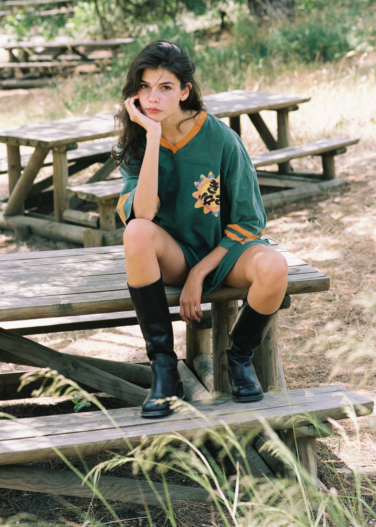 Woman sitting on a wooden bench in a park-like setting