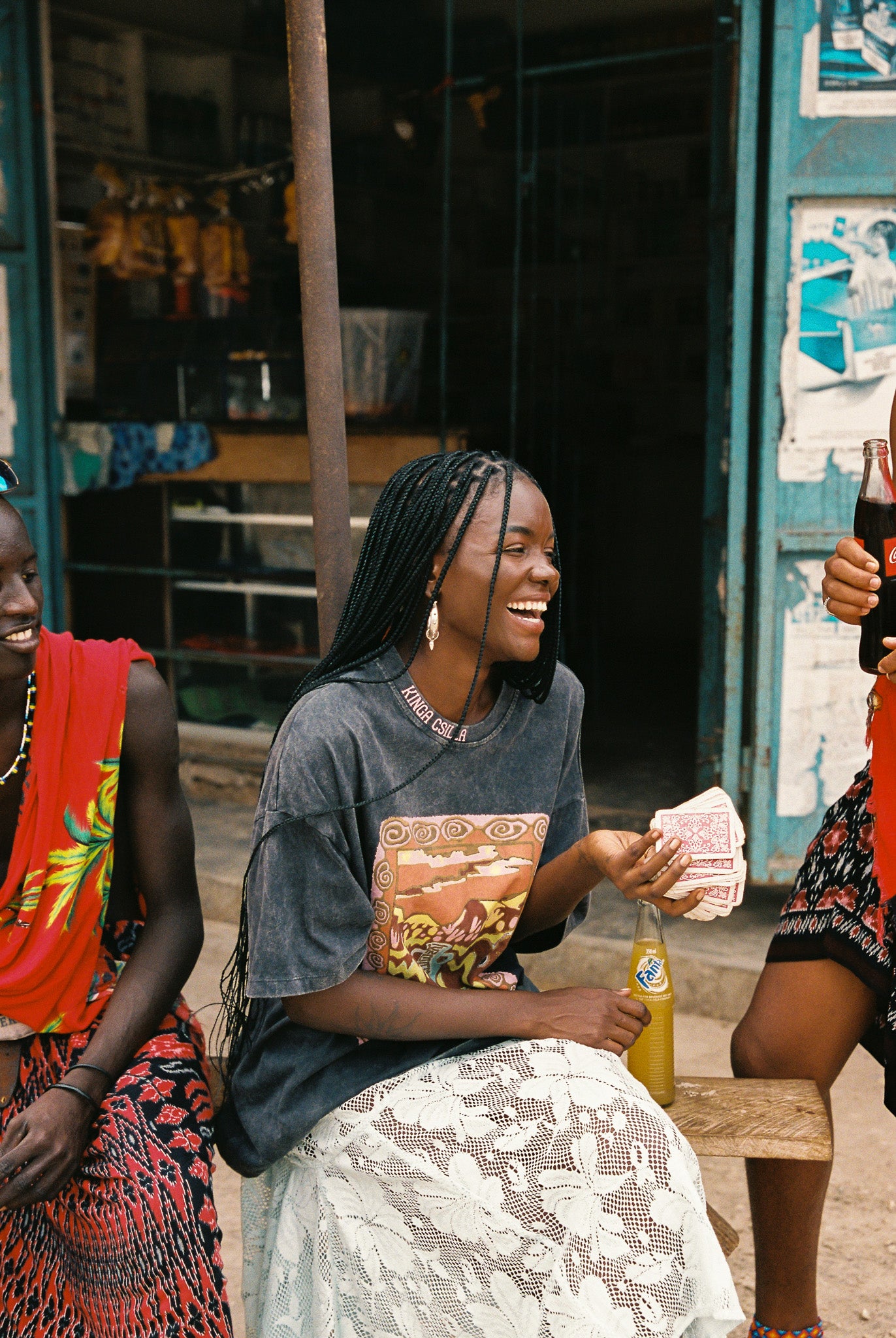Woman wearing a light blue lace skirt with an oversized black graphic tee