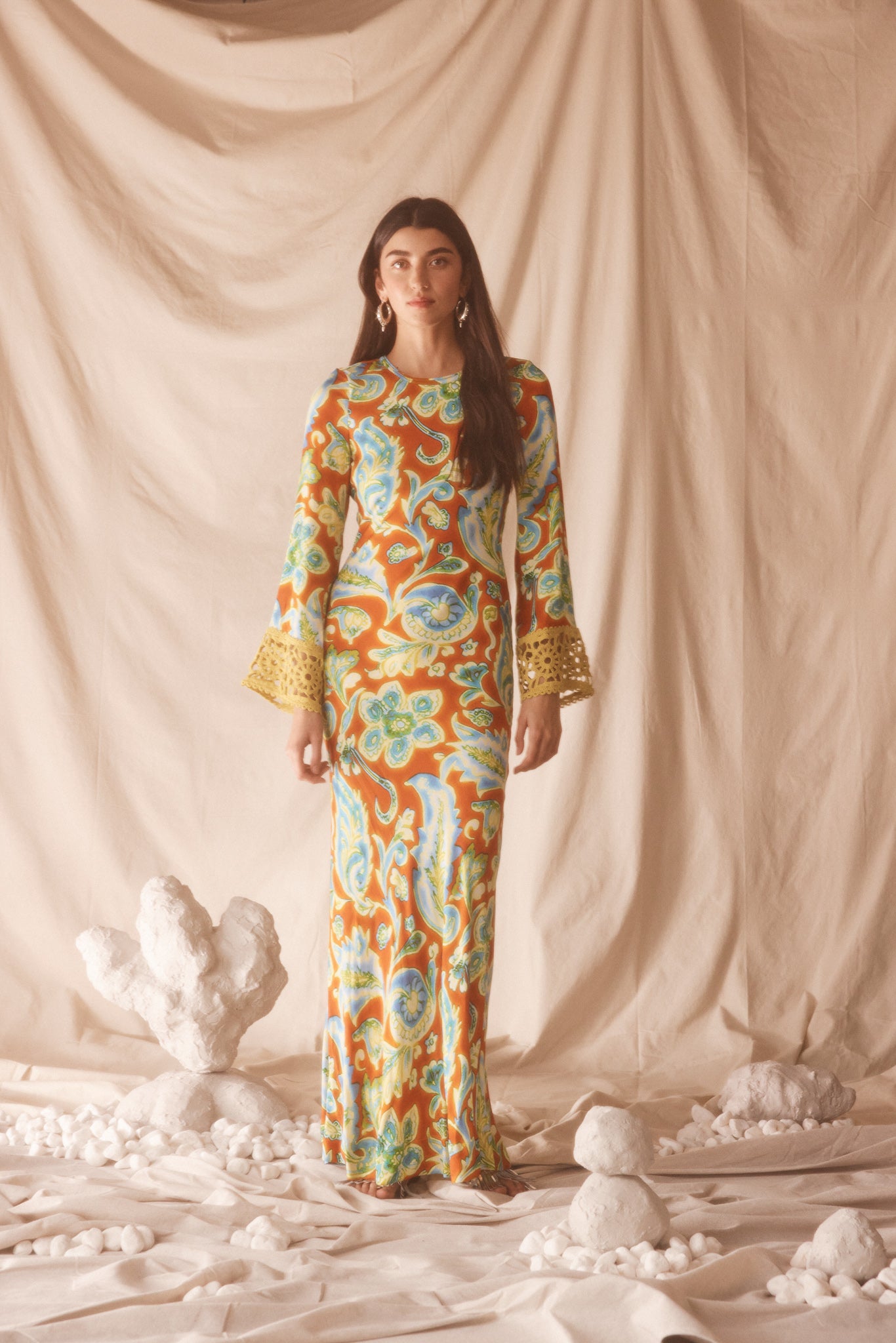 Woman wearing a colorful orange, blue and green patterned dress with lime green embroided contrast trim detail