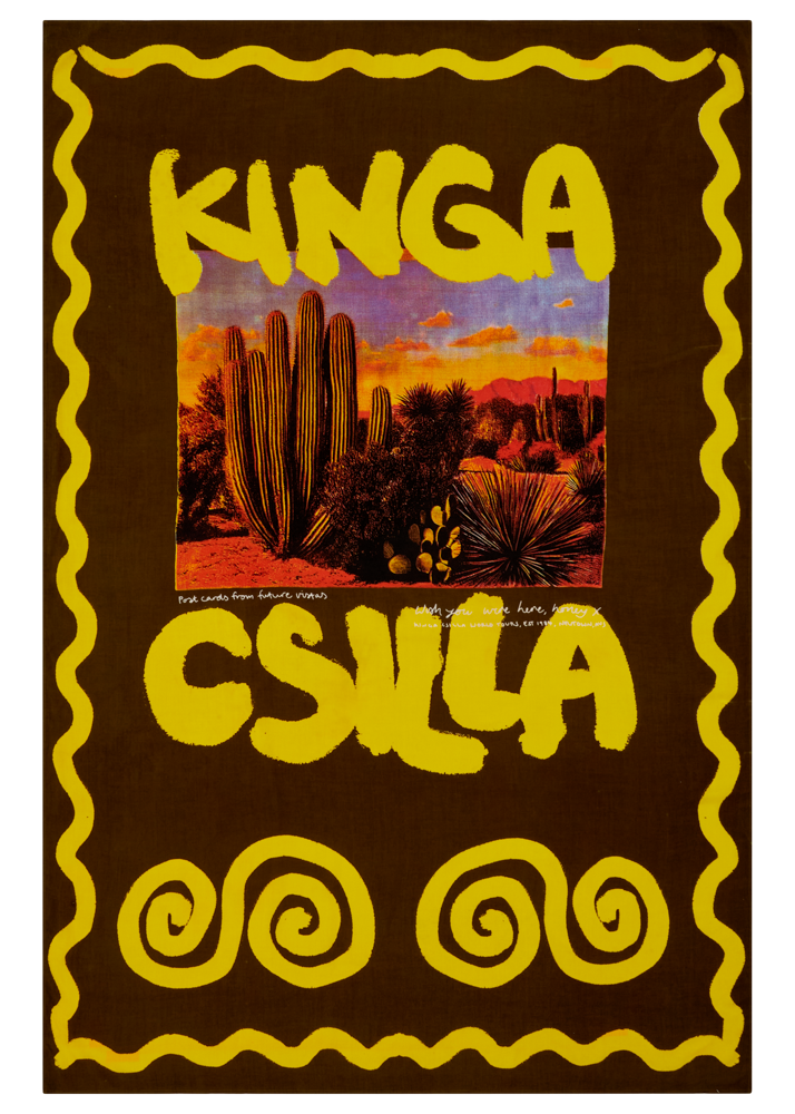 Sarong with 'KINGA CSILLA' text and desert scene in a decorative frame.