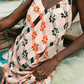 Person wearing a pink floral dress with a blurred background