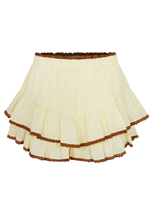 A cream yellow tiered mini skirt with brown lace hem details, displayed on a white background.