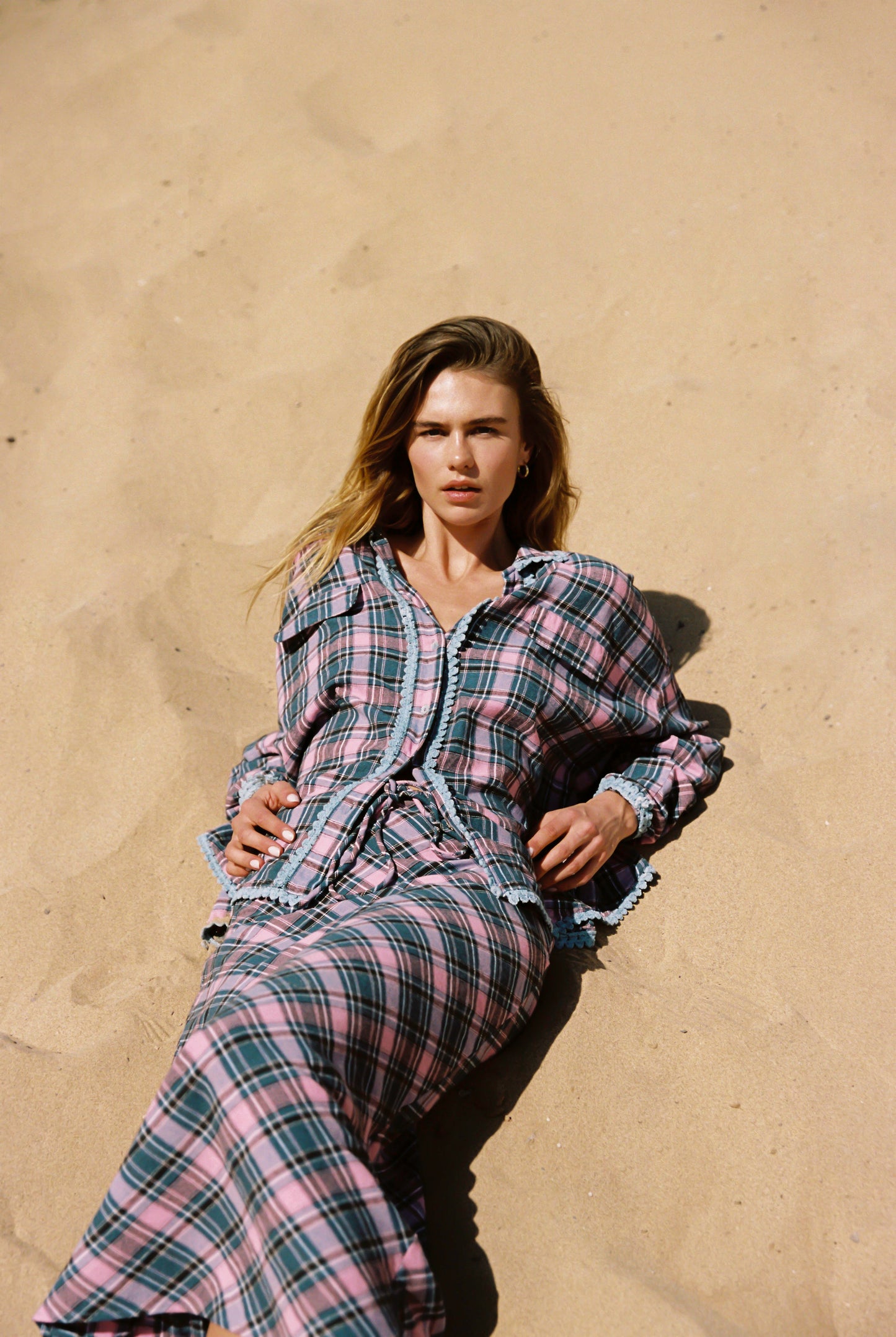 Woman wearingsoft cotton Candy Plaid set in pink and lilac; relaxed button-down shirt and bias-cut column skirt