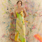 Woman in a yellow dress with colorful abstract art in the background