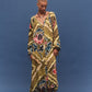 Woman wearing a colorful patterned dress against a blue background