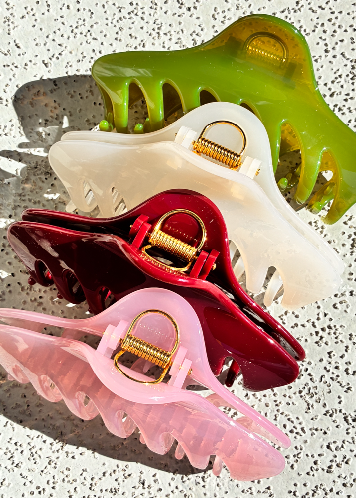 Set of colorful claw clips on a textured surface