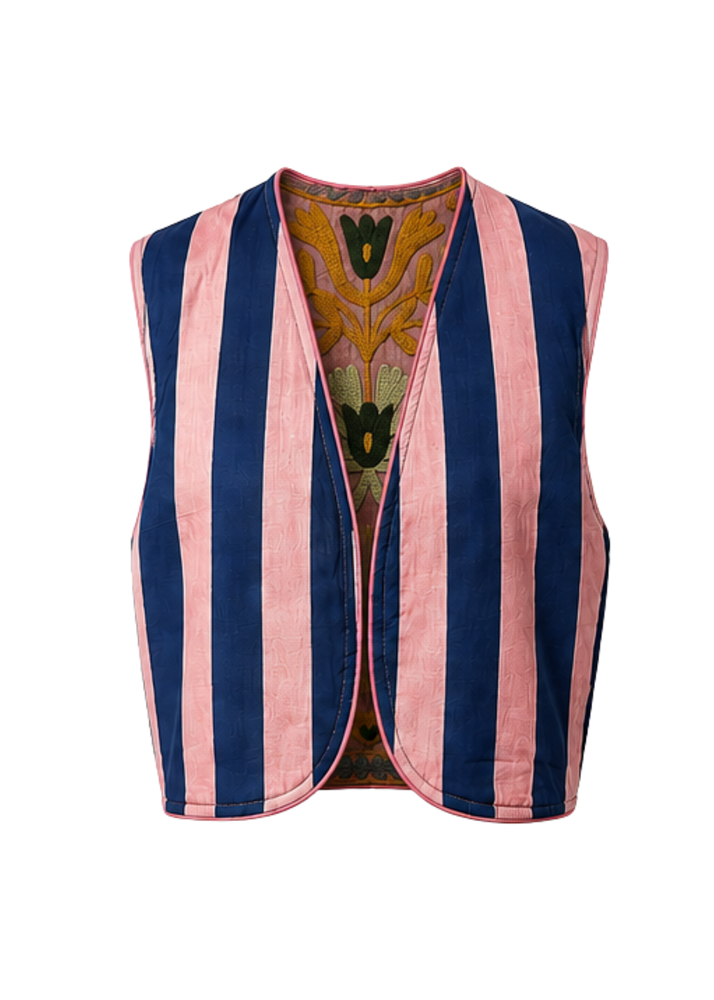 A sleeveless reversible vest with vertical pink and navy blue stripes, featuring a colorful embroidered floral pattern lining the open front, shown against a plain white background.