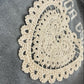 Crocheted doily on a textured surface