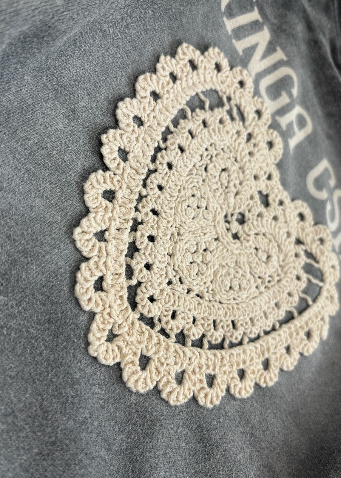 Crocheted doily on a textured surface