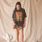 Woman wearing a black graphic t-shirt with desert print