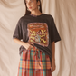 Woman wearing a black graphic t-shirt with desert print
