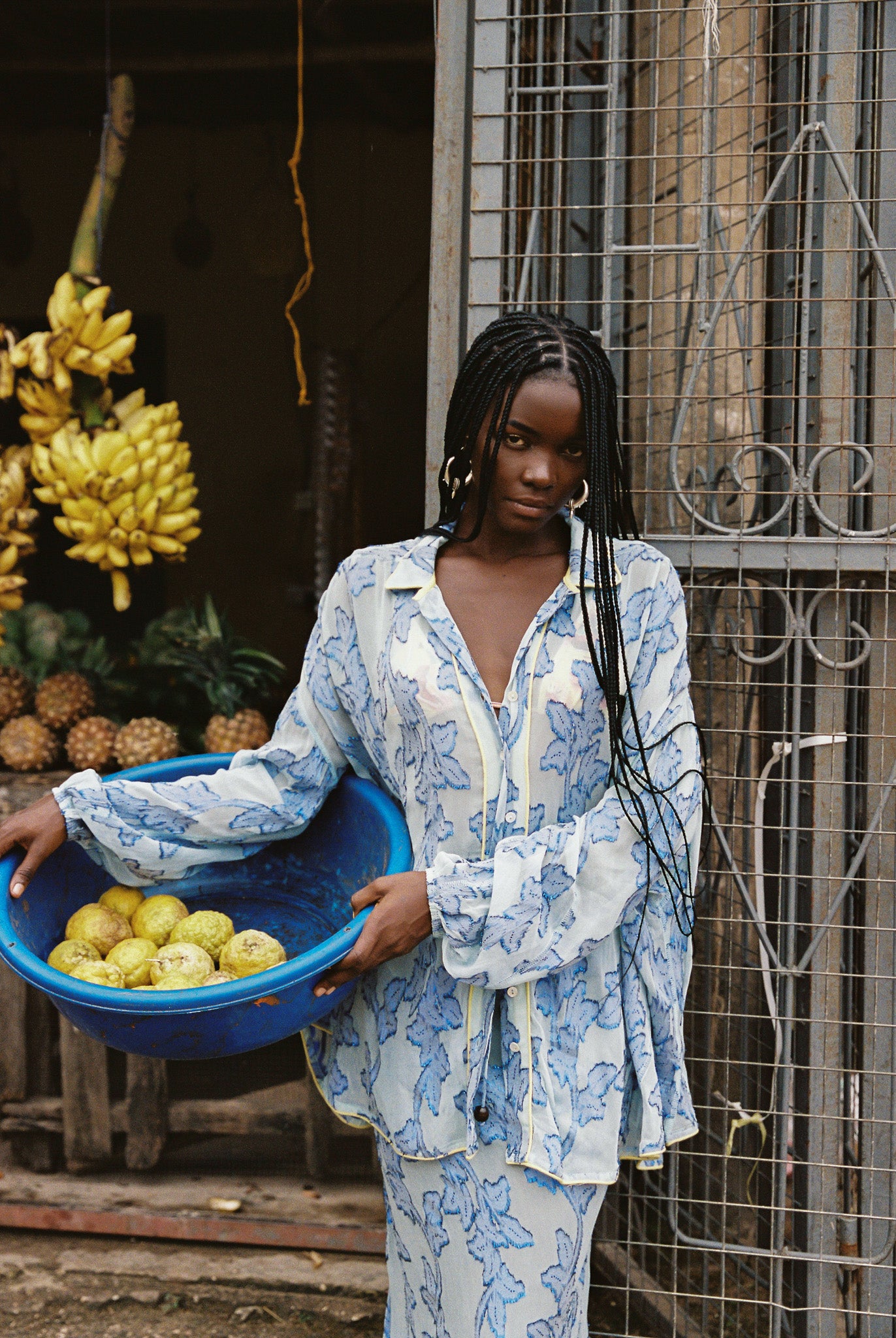 Woman wearing sheer cotton in electric blue botanical embroidery with contrast piping, curved hem, and oversized bohemian silhouette.