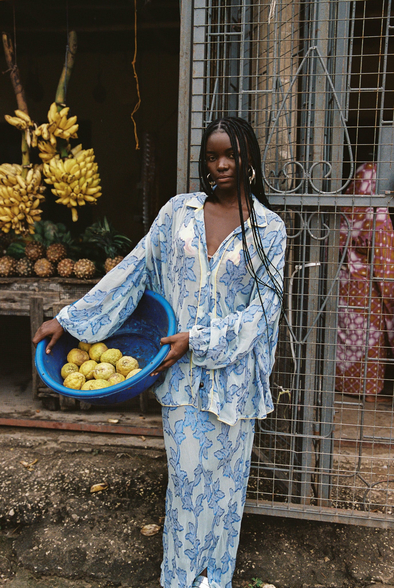 Woman wearing sheer cotton in electric blue botanical embroidery with contrast piping, curved hem, and oversized bohemian silhouette.