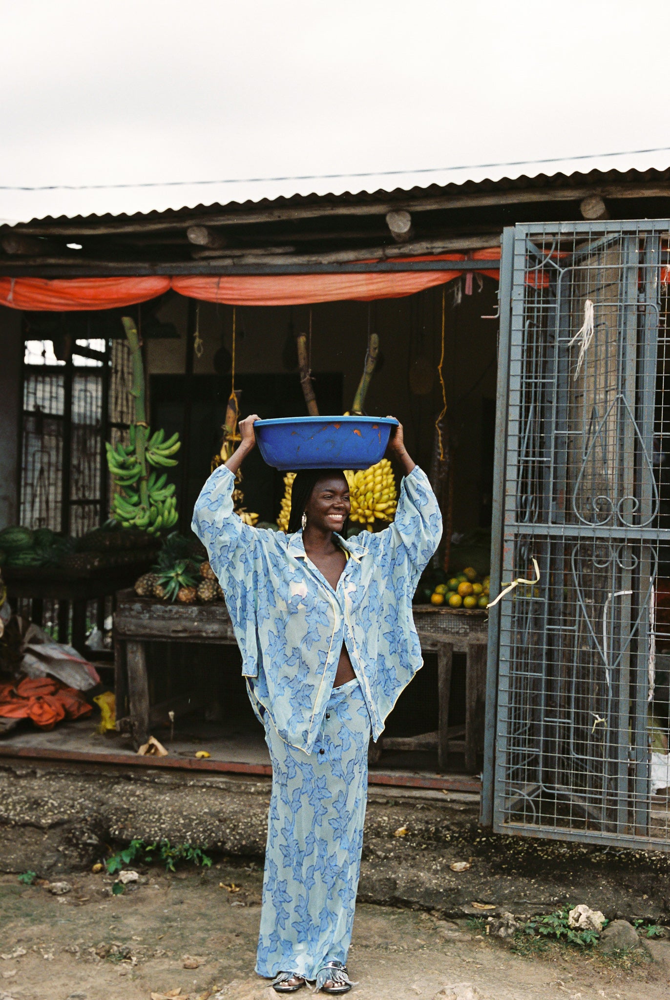 Woman in semi-sheer blue botanical embroided skirt and skirt set. 