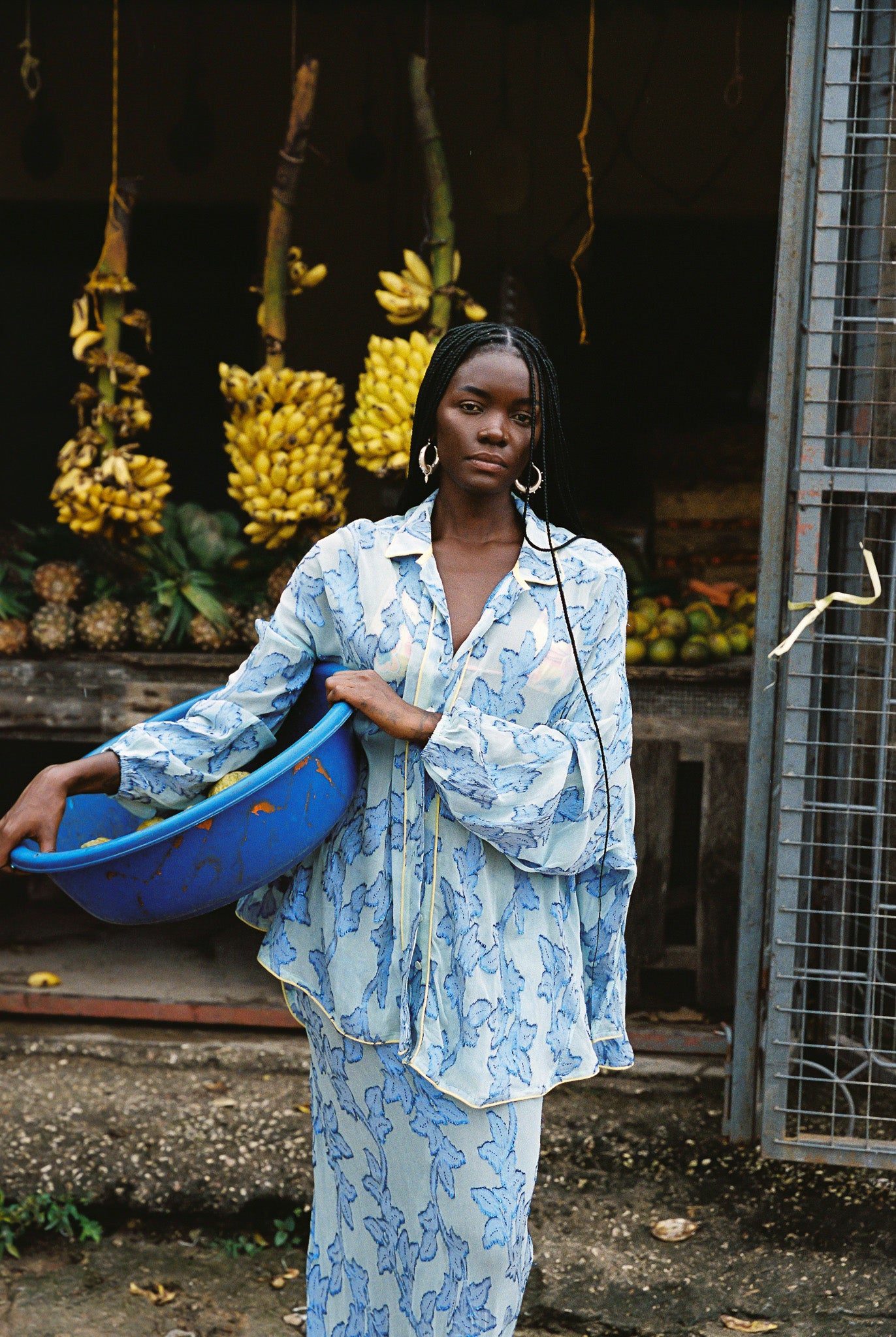 Woman in semi-sheer blue botanical embroided skirt and skirt set. 