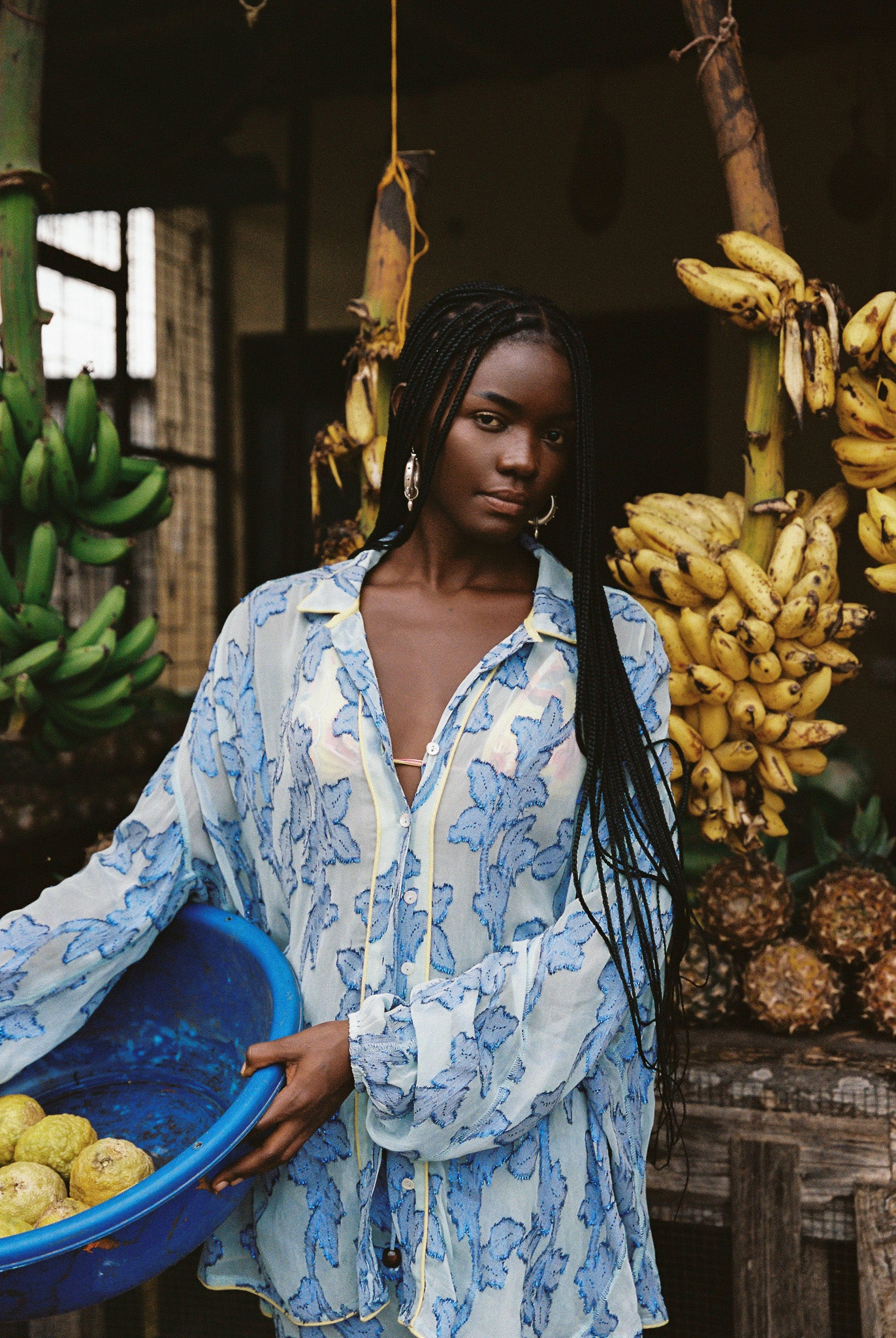 Woman in semi-sheer blue botanical embroided skirt and skirt set. 