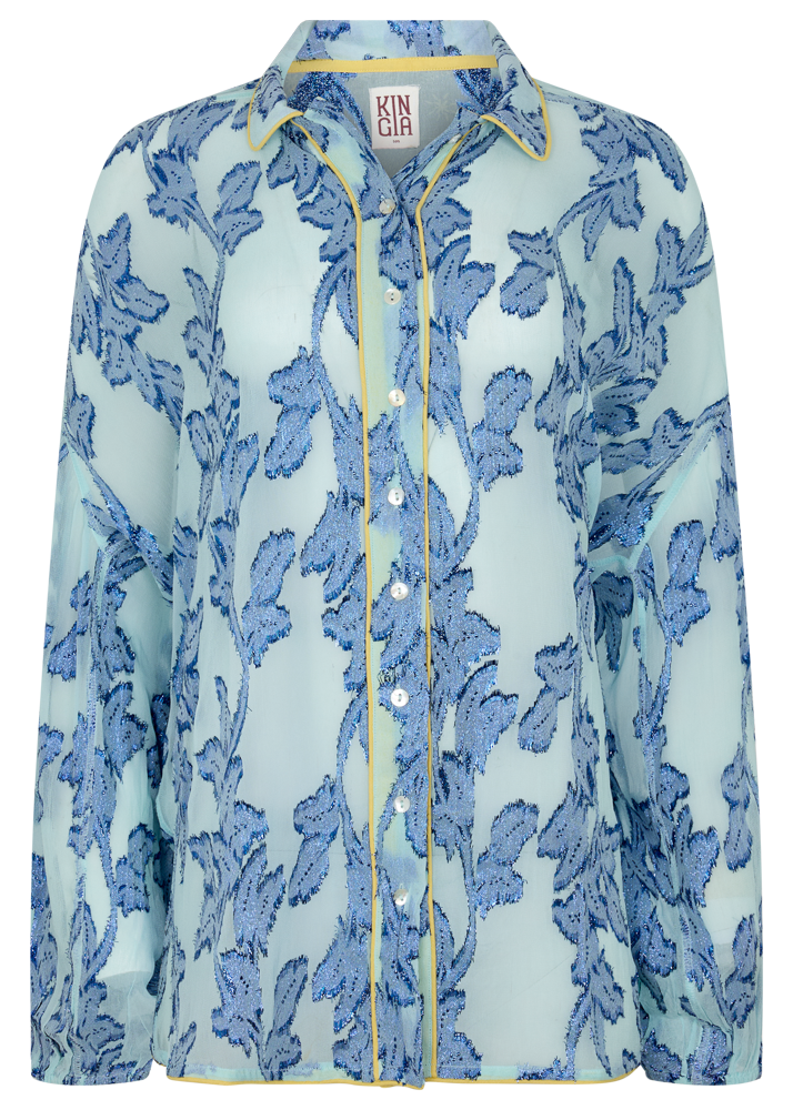 Sheer cotton in electric blue botanical embroidery with contrast piping, curved hem, and oversized bohemian silhouette.