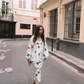 Model wearing Kinga Csilla Aquarius Chalm Shirt in celestial baby blue linen with matching Aquarius Column Skirt, styled as a coordinated set with sandals and blue sunglasses in a Parisian street
