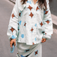 Model wearing Kinga Csilla Aquarius Chalm Shirt in baby blue linen with celestial brown and blue print, styled with matching Aquarius Column Skirt and holding blue sunglasses on the street