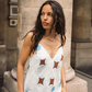 Close-up of Kinga Csilla Aquarius Sia slip dress in baby blue linen with celestial print and plunging neckline