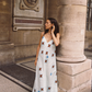 Model wearing Kinga Csilla Aquarius Sia slip dress, maxi length linen with celestial print, side view