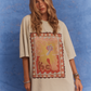 Studio shot in Kinga Csilla Hibiscus Tee paired with TWILIGHT VELVET FLARE PANT, modern bohemian styling.