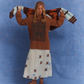 Model wearing Kinga Csilla Lino Roses Tee brown long sleeve styled with Aquarius Slip Dress and brown sandals, holding Surf itty Cardigan above shoulders, photographed in front of blue backdrop